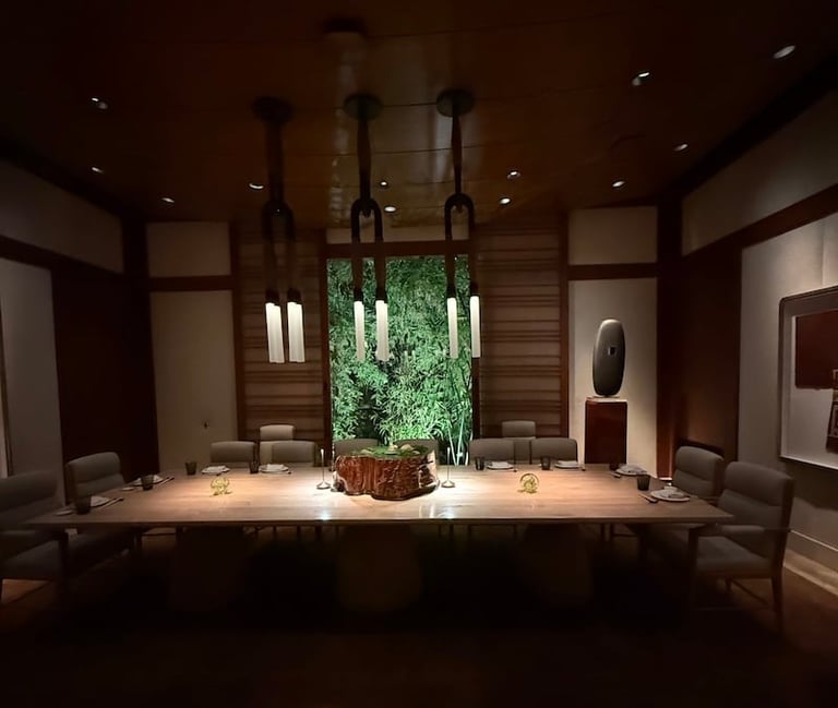 Modern spa or wellness reception area with wood paneling, illuminated counter, green living wall backdrop, and ambient lighting